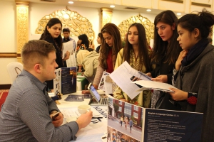 Pakistani students speaking to U.S. representatives at a college fair in Islamabad. 