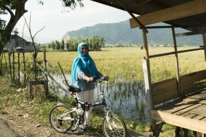 Dr. Aslam parked near a marsh on her bike ride in Aceh with 'Women on Wheels.'