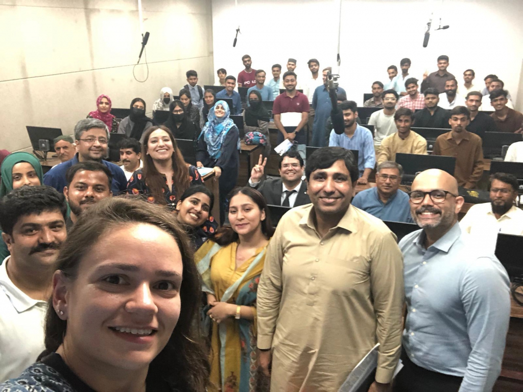 Students, Team EducationUSA, and officers from the U.S. consulate in Karachi pose for a picture at the University of Larkana outreach